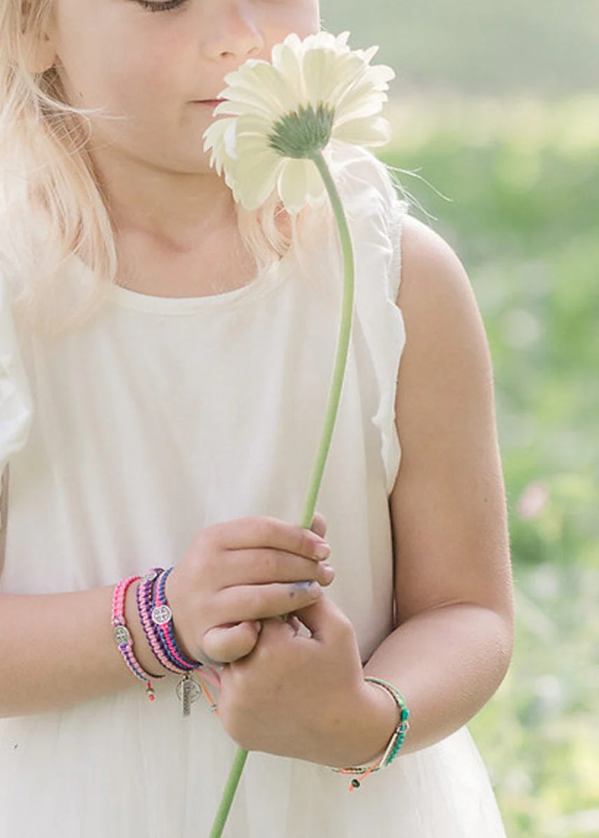 Young girl with pink and purple faith bracelets – Christian gift for children