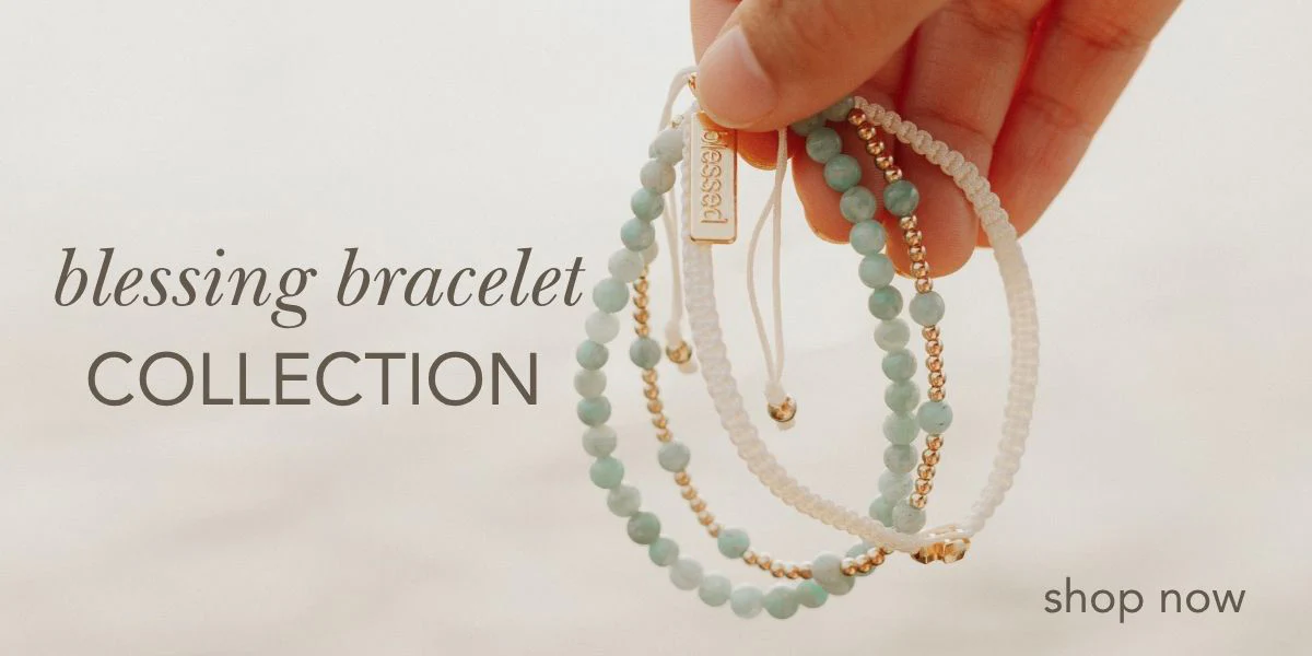 Hand holding pastel blessing bracelets with gold accents – faith jewelry collection