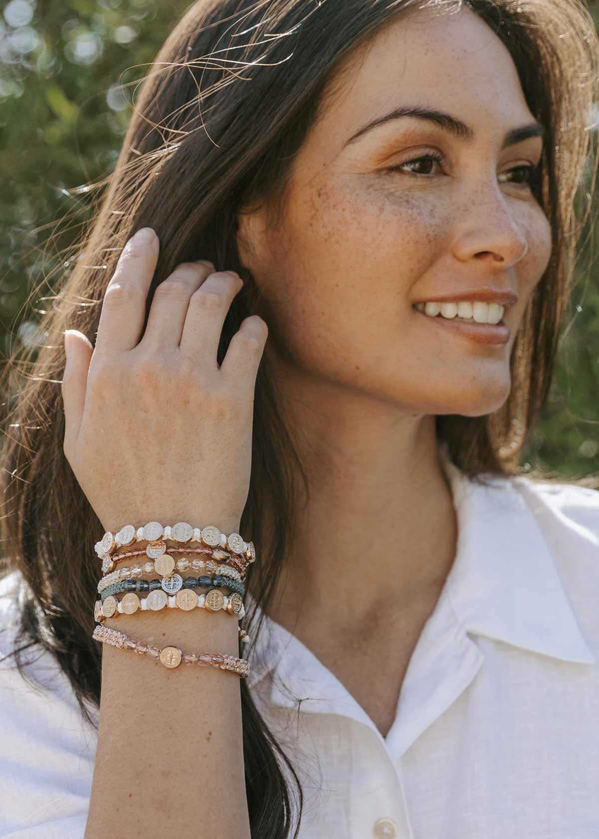 Woman wearing layered blessing bracelets – Christian jewelry gift for her